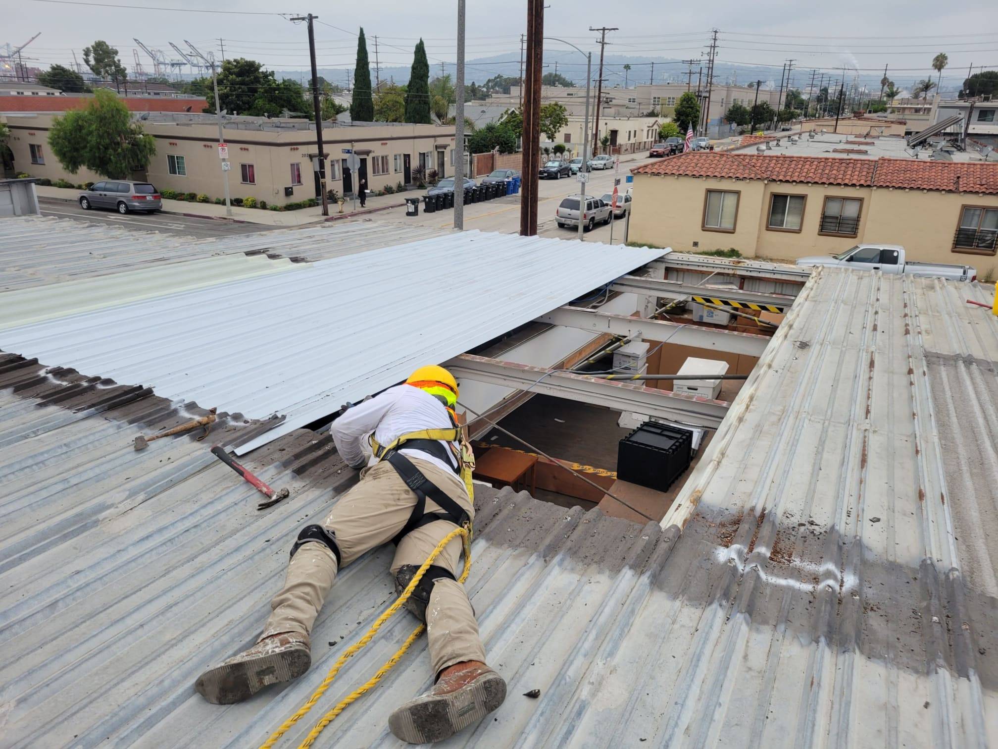commercial roofers alhambra A commercial roofing contractor in Alhambra is working on the roof of a building.
