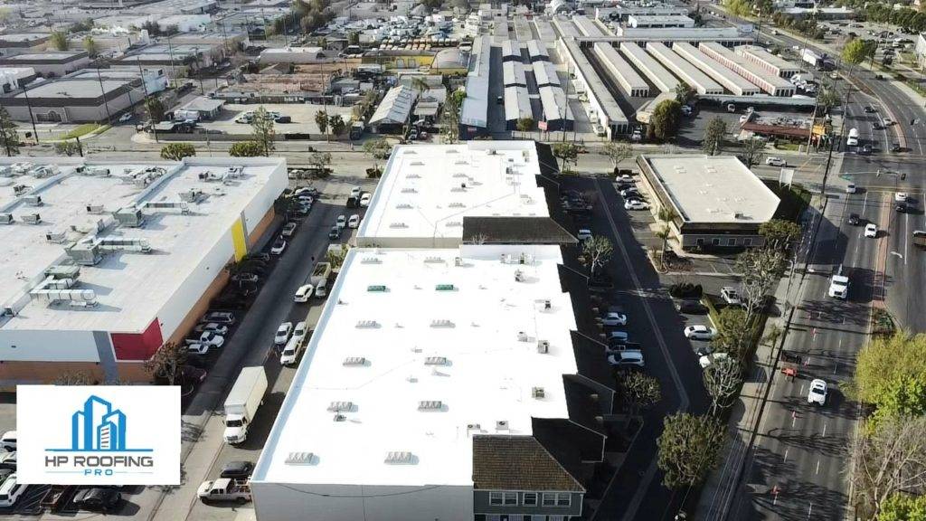 An aerial view of a parking lot and a building.