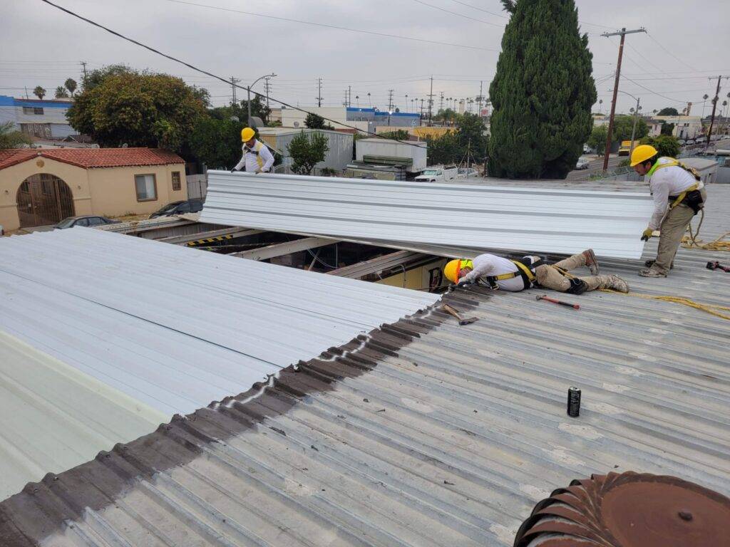 Two men working on the roof of a building.