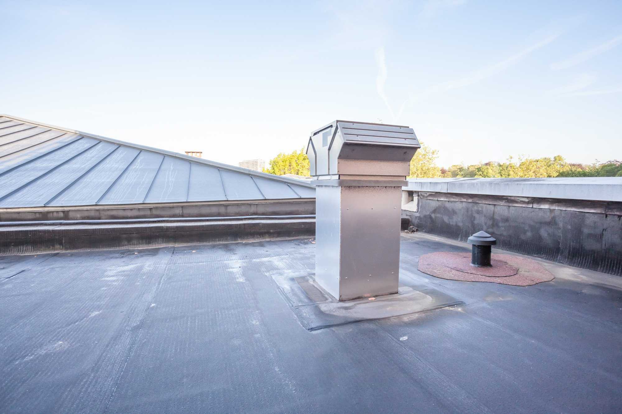A metal chimney installed by commercial roofers on the roof of a building in Alhambra. A metal chimney installed by commercial roofers on the roof of a building in Alhambra.